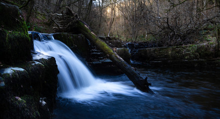 Magnificent long exposure of a waterfall in Brecon Beacons National Park at sunset in Wales, UK.