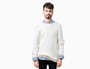 Fototapeta premium Young handsome man wearing winter sweater over isolated background skeptic and nervous, frowning upset because of problem. Negative person.
