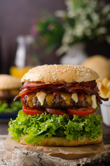 Homemade bacon burger with lettuce and cheddar