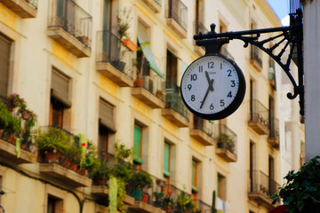 Fototapeta na wymiar Clock attached to the building - Barcelona
