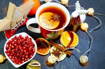 A hot drink with spices wrapped in a woolen shawl. Selective focus.Still life, food and drink, seasonal and holidays
