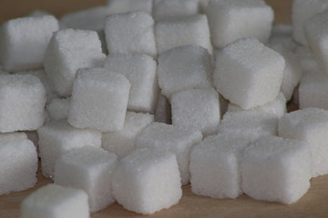 White sugar cubes on wooden desk