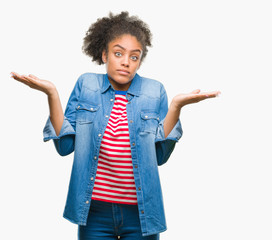 Young afro american woman over isolated background clueless and confused expression with arms and...