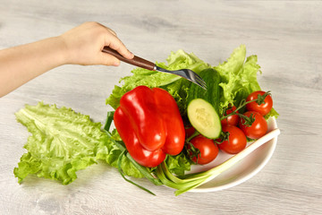 A child pins vegetables on a fork