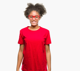Fototapeta na wymiar Young afro american woman wearing glasses over isolated background with a happy and cool smile on face. Lucky person.
