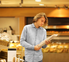 Teenager choosing bread  from a supermarket