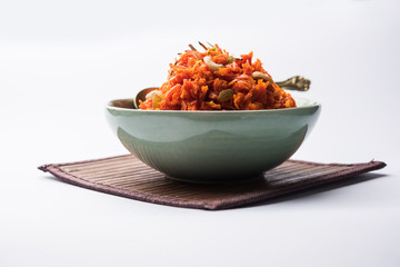 Gajar ka halwa is a carrot-based sweet dessert pudding from India. Garnished with Cashew/almond nuts. served in a bowl. - obrazy, fototapety, plakaty