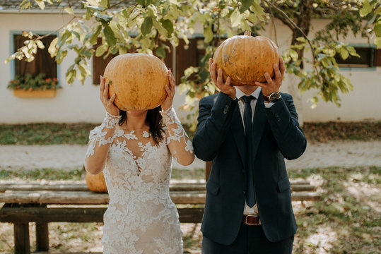 Crazy couple with pumpkins. Crazy wedding.