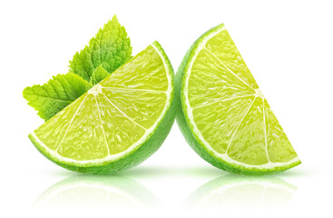 Isolated lime slices. Two pieces of lime fruit with mint leaf isolated on white background with...