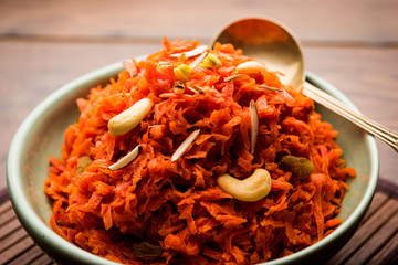 Gajar ka halwa is a carrot-based sweet dessert pudding from India. Garnished with Cashew/almond nuts. served in a bowl.
