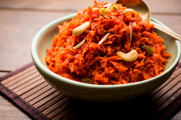 Fototapeta Gajar ka halwa is a carrot-based sweet dessert pudding from India. Garnished with Cashew/almond nuts. served in a bowl. obraz