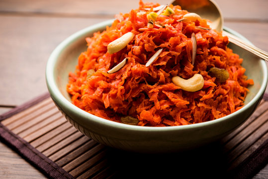 Gajar ka halwa is a carrot-based sweet dessert pudding from India. Garnished with Cashew/almond nuts. served in a bowl.