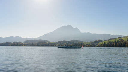 Touristic boat on the Lake of Luzern on a silhouette of Pilatus mountain