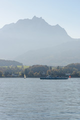 Touristic boat on the Lake of Luzern on a silhouette of Pilatus mountain