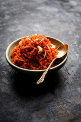 Gajar ka halwa is a carrot-based sweet dessert pudding from India. Garnished with Cashew/almond nuts. served in a bowl.