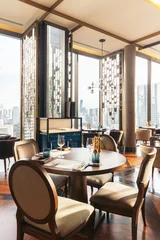 Fotobehang Hotel chique Modern luxury decorated interior restaurant that can view Bangkok cityscape. Elegant design for fine dining.  © artitwpd