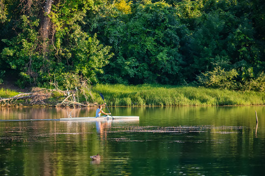 Novi Sad, Serbia - August 04, 2018: Danube island (&Scaron;odro&scaron;) near Novi Sad, Serbia. Man in kayak paddling on river.