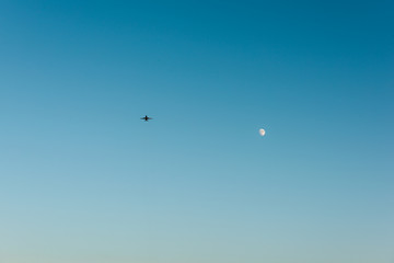 Clear sky with a plane and moon