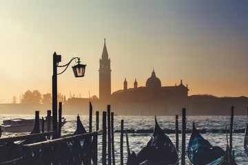 Sunrise silhouette of San Giorgio Maggiore and gondolas, Venice, Italy