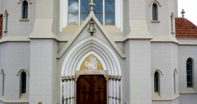 Close view of the main church of the city of Jau with a cityscape at background on a beautiful sunny afternoom. Sao Paulo State. Panoramic plane tilt up