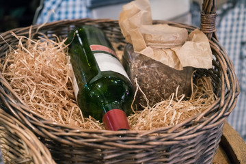 Bottle wine in basket with straw. Rustic style