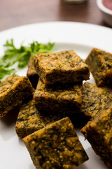 A savory cilantro cake or kothimbir vadi in square shape which is first steamed and then fried...