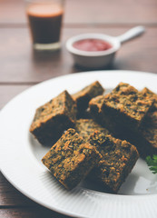 A savory cilantro cake or kothimbir vadi in square shape which is first steamed and then fried...