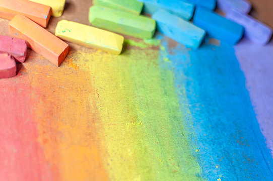 Colorful chalks in rainbow colors / soft pastel chalks. Handdrawn rainbow gradient, rough texture. Symbol of childhood, freedom, equality.