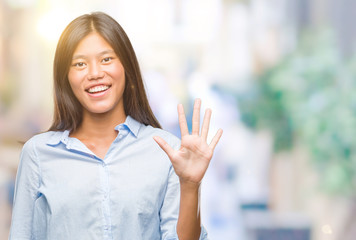 Young asian business woman over isolated background showing and pointing up with fingers number five while smiling confident and happy.
