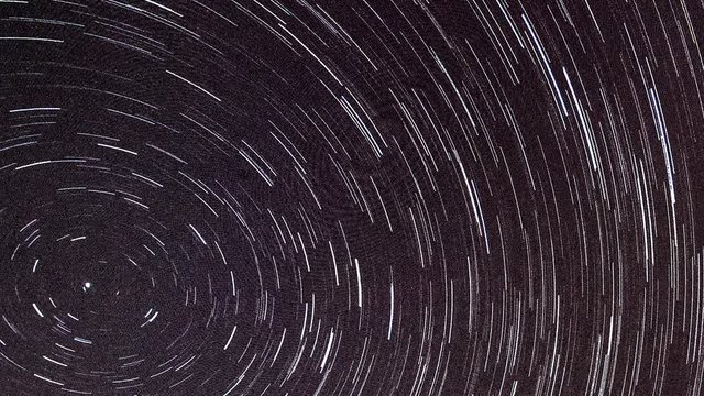 Spinning star trails in a night sky.