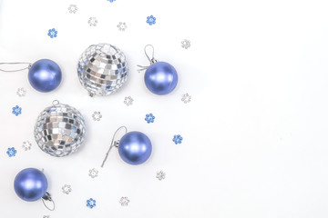 Christmas composition. Christmas balls, blue and silver decorations on white background. Top view, copy space.