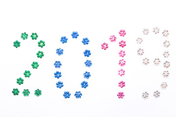 2019 lined with sequins on white background. Christmas composition. Top view, close-up