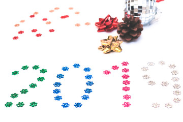 2019 lined with sequins on white background. Christmas composition. Top view, close-up