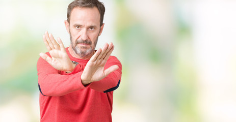 Handsome middle age hoary senior man wearing winter sweater over isolated background Rejection expression crossing arms and palms doing negative sign, angry face