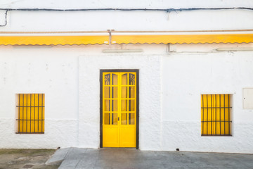 Facade with yellow door and windows