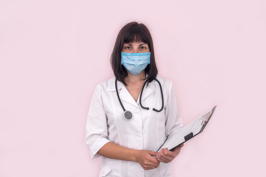 Doctor In Mask With Prescription On Clipboard