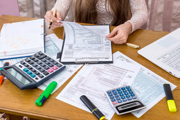 Woman looking through 1040 form preparing to fill