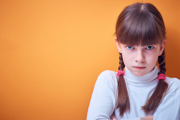 angry Caucasian teen girl on colored background, place for text