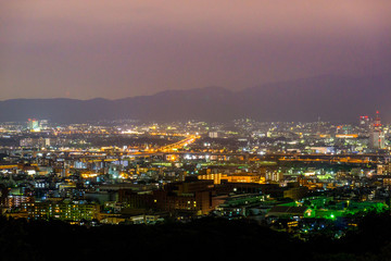 Beautiful nightview of Kyoto cityscape with mountains in the background