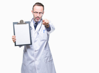 Middle age senior hoary doctor man holding clipboard isolated background pointing with finger to the camera and to you, hand sign, positive and confident gesture from the front