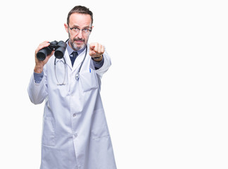 Middle age senior hoary doctor man looking through binoculars isolated background pointing with finger to the camera and to you, hand sign, positive and confident gesture from the front