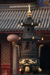 Iron incence tower with golden bells and tip infront of the main hall of a buddhist temple in old town Suzhou, China, Asia