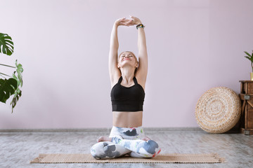 Fitness woman practices yoga asana parvatasana