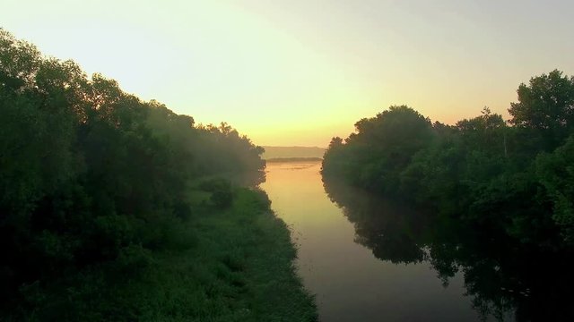 aerial view of river at sunrise 4K, fly over morning mist on the river, Very high view of the river at sunrise, Aerial view of mystical river at sunrise with fog, sun above the river aerial