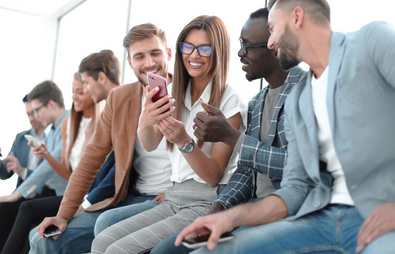 group of young people with smartphones