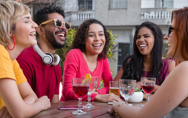 Group of happy smiling people partying together at cafe bar outdoor