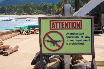 Attention sign prohibiting drone use by sea. Unauthorized operation of drone is prohibited...