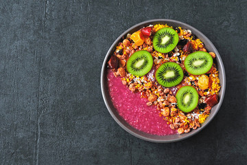 Colorful healthy Acai bowl. Breakfast bowl with acai smoothie, oatmeal, granola and fruit. Fitness food. Vegan bowl