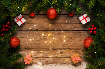 Fototapeta na wymiar Christmas lights background, gifts and decoration on old wooden floor