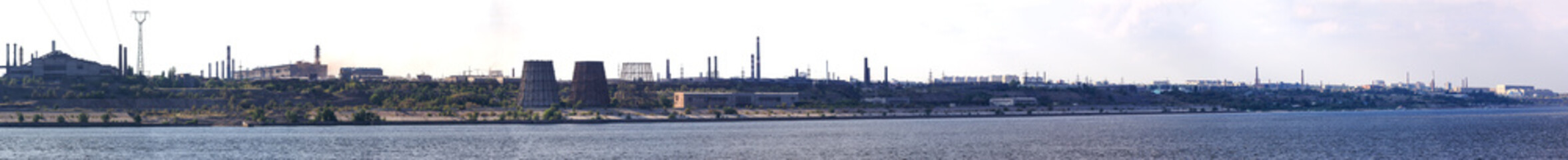 Fototapeta na wymiar Panoramic view of ironworks on river coastline